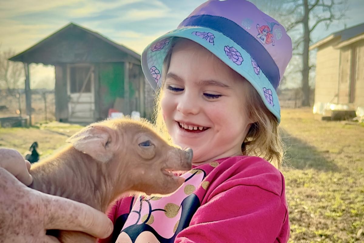 Carly made a new little piggy friend. Both look a little happy about it!